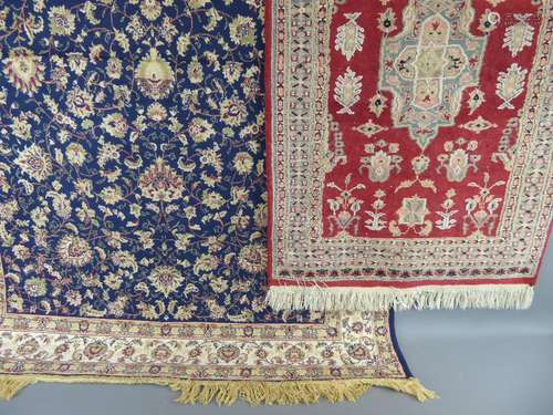 Two Woollen Rugs, the first having blue ground with floral design and border, approx 188 x 136 cms, the other having red ground and central motif with cris-cross border pattern, approx 127 x 79 cms.