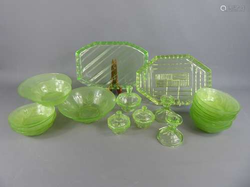 A Selection of English Art Deco 1910-1937 Uranium Glass. Twelve bowls of Jobling Glass reg. nr. 777133, 10 x 14 cms and 2 x 21 cms together with a dressing table set comprising two candle holders and three trinket boxes on tray.