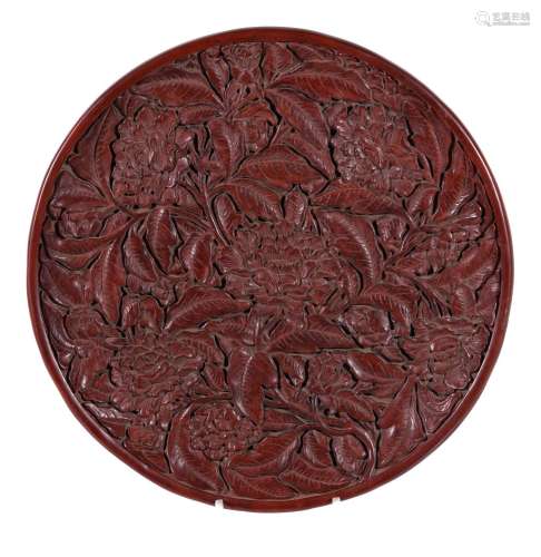 A large Chinese red lacquer tray, in Ming style, of shallow circular form, the interior …