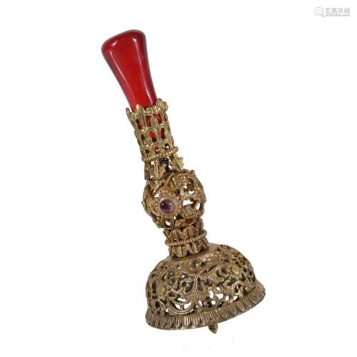A Chinese gilt metal and red glass hat finial