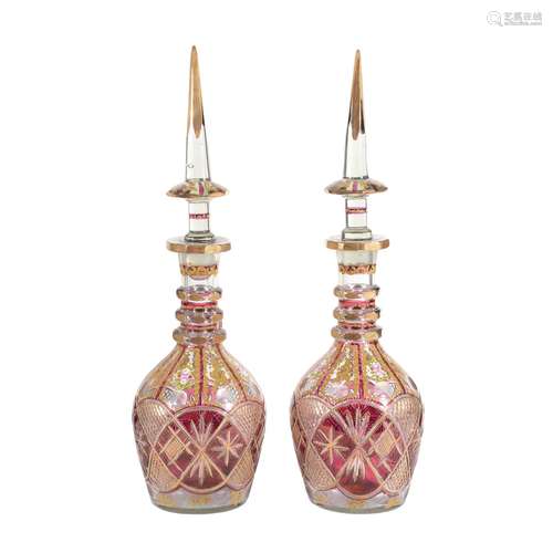 A pair of Bohemian/Czech clear, ruby-flashed and enamelled glass large bottles and spire stoppers