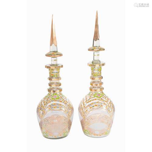 Two similar Bohemian/Czech or Beykoz clear and enamelled glass large bottles and spire stoppers