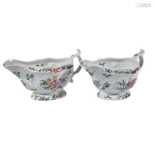 A pair of Worcester moulded polychrome sauce boats