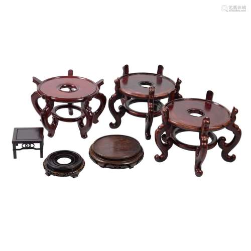 Six various Chinese wood stands, 20th century, comprising a large circular pair …