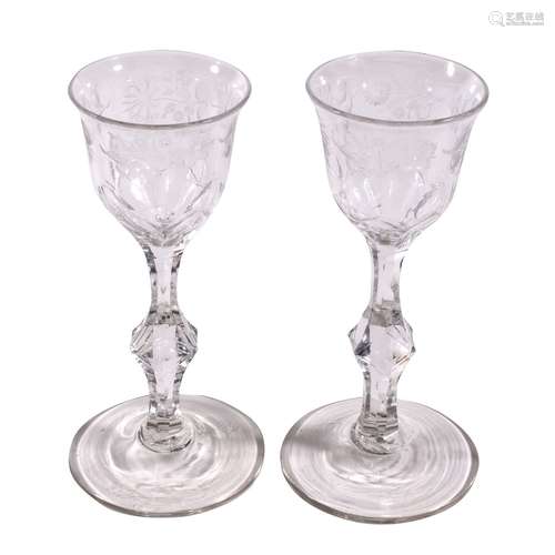 A pair of engraved facet stemmed wine glasses