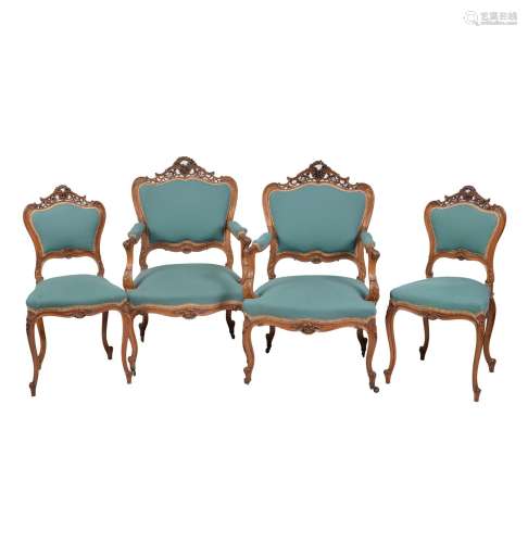 A set of four French carved walnut and upholstered salon chairs
