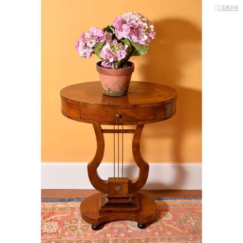 A walnut oval occasional table in Empire style