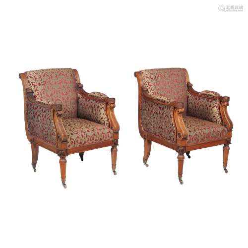 A pair of mahogany and upholstered armchairs in Regency style