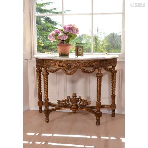 A carved giltwood and marble topped console table