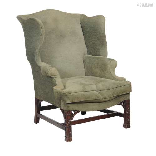 A mahogany and upholstered wing armchair