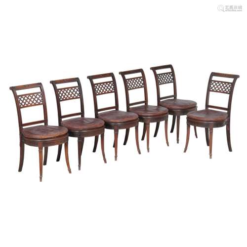 A set of twelve mahogany and cane seated dining chairs in Regency style