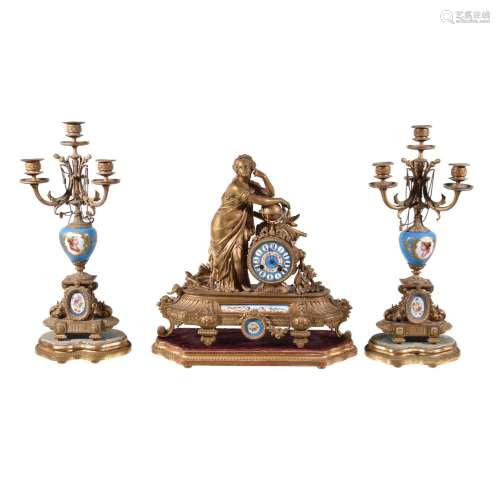 A gilt spelter and Sevres style porcelain mounted figural mantel clock and associated garniture