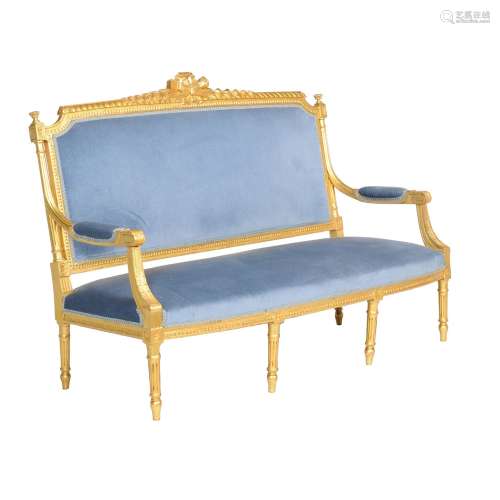 A carved giltwood settee in Louis XVI style