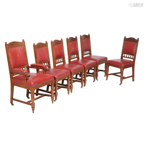 A set of twelve oak and red leather upholstered dining chairs