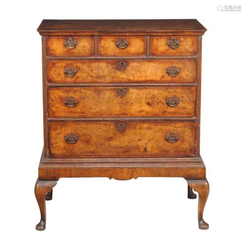 A walnut and feather banded chest on stand in George II style