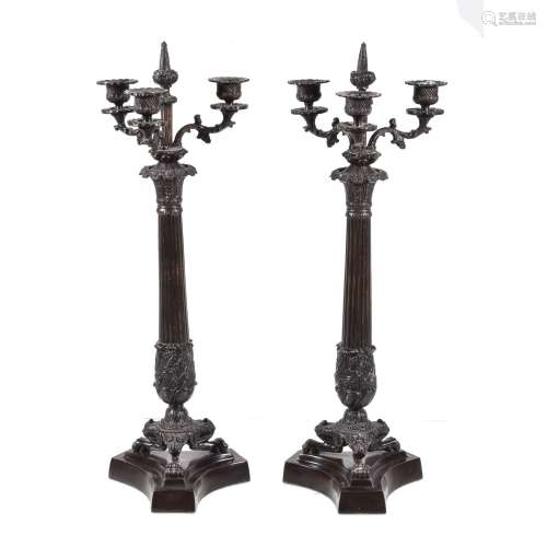 A pair of patinated metal three light candelabra in Restauration style
