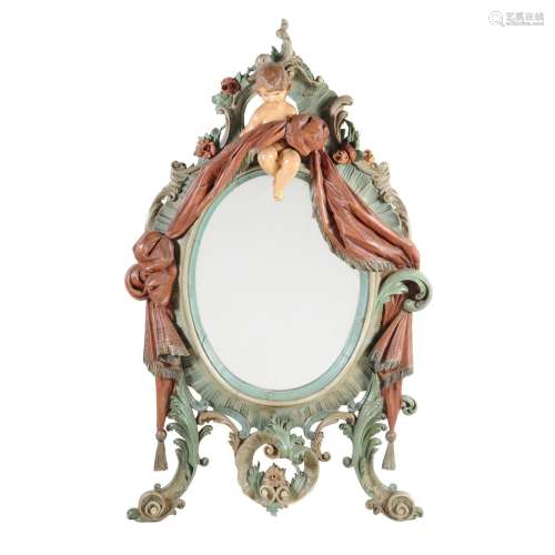 A North European carved wood and polychrome painted wall mirror
