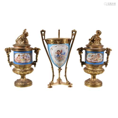 A pair of Sevres-style gilt-metal mounted pedestal urns and covers