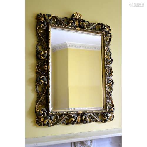 A carved giltwood and green painted wall mirror