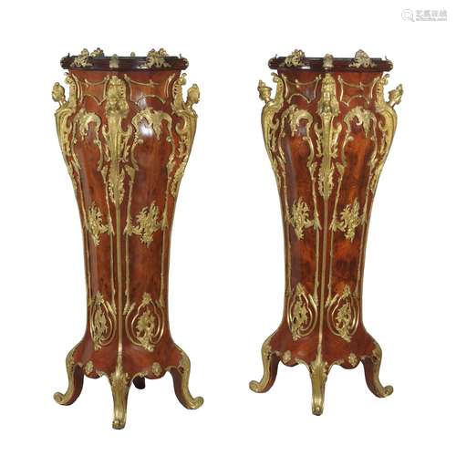 A pair of walnut veneered and gilt metal mounted torchere or vase stands in Louis XV style