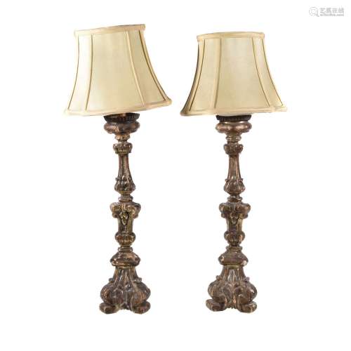 A pair of Italian carved and silvered wood altar sticks in Baroque style