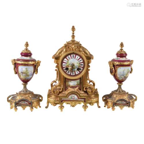 A gilt spelter and porcelain clock garniture