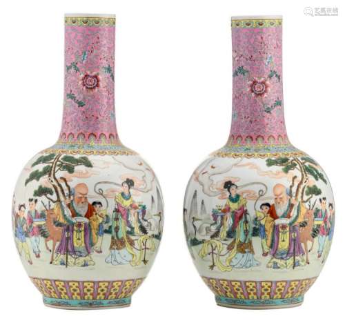A pair of Chinese famille rose bottle vases, decorated with an animated scene in a landscape and calligraphic texts, marked, H 56 cm