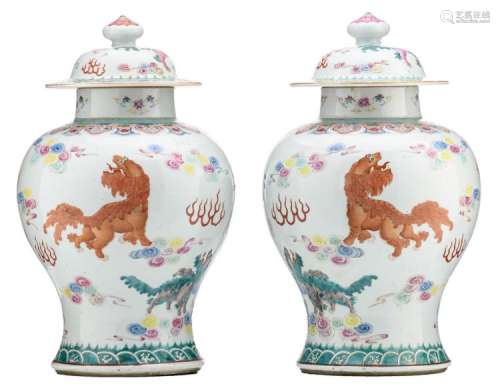 A pair of Chinese famille rose vases and covers, decorated with Fu lions amid clouds, 19thC, with a Yongzheng mark, H 42 cm