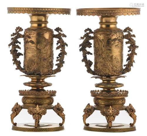 A pair of Japanese gilt bronze ornamental vases, relief decorated with animated scenes, birds of prey and mythical animals, the handles pine tree shaped, the feet elephant head shaped, marked, Meiji and period, H 68,5 cm