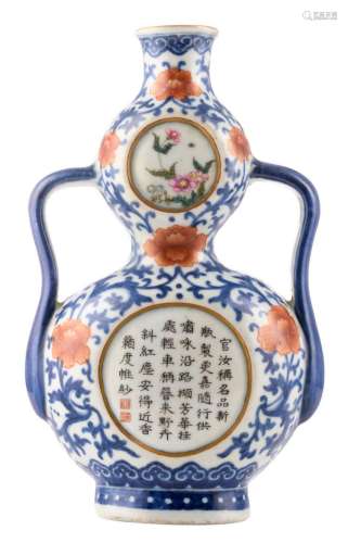 A Chinese blue and white and iron red famille rose double gourd wall vase, floral decorated with calligraphic text, with a Qianlong mark, H 23 cm