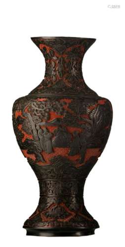 A Chinese carved red and black lacquer floral decorated baluster shaped vase, the body with figures in a garden, 19thC, H 46 cm