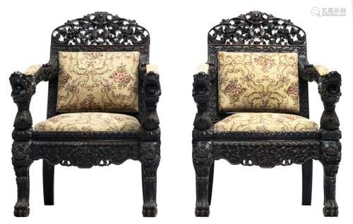 A fine pair of Chinese richly carved open work hardwood armchairs, the armrests dragon decorated, about 1900, H 103 - W 67,5 - D 73,5 cm