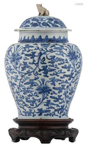 A Chinese blue and white vase and cover, decorated with flower branches, Kangxi, 18thC, on a matching carved hardwood base, H 52 (without base) - 61,5 cm (with base)