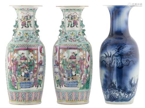 A pair of Chinese famille rose floral decorated vases, the roundels with a court and a warrior scene, 19thC; added a Chinese blue and white decorated vase with a dragon and a carp, H 59,5 - 60 cm