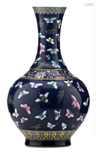 A Chinese blue ground famille rose bottle vase, overall decorated with butterflies and lotus, Guangxu marked, H 39 cm