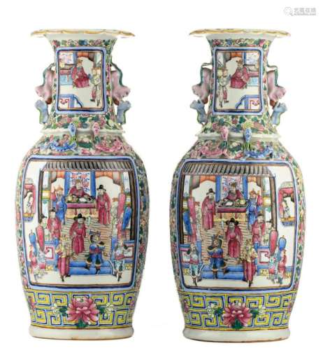 A pair of Chinese famille rose floral decorated vases, the roundels with warriors and court scenes, 19thC, H 58 cm