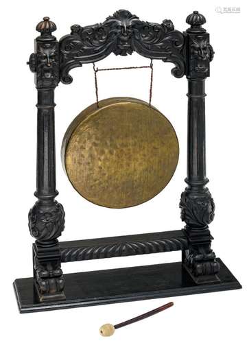 A brass Oriental gong mounted in a Renaissance revival ebonised wooden holder, the holder 19thC, H 104 - W 75 cm