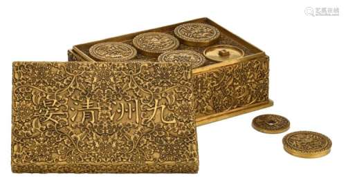 A fine Chinese basso relievo worked bronze three-part collector’s box and cover with inside a compilation of ancient coin replica's, with a Qianlong mark, H 9 – W 22 – D 15 cm