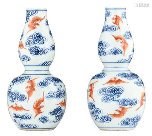 A pair of Chinese cobalt blue and iron red double gourd vases, decorated with bats among clouds, with a Xuantong mark, H 22 cm