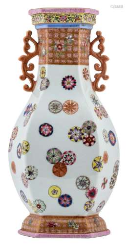 A Chinese famille rose baluster shaped hexagonal vase, decorated with Buddhistic styled flowers, with a Qianlong mark, H 31 cm
