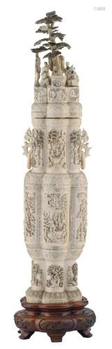 An impressive Chinese richly carved ivory lobed vase and cover depicting the Eight Immortals and various animated scenes, partially tinted, on a matching carved wooden base, early 20thC, H 137,3 (without base) - 154 cm (with base)