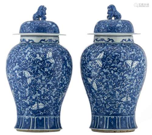 A pair of Chinese blue and white vases and covers, decorated with butterflies and floral motifs, H 69,5 - 70 cm