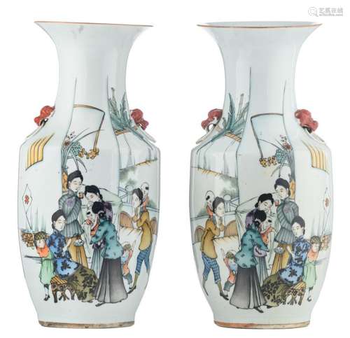 A pair of Chinese polychrome decorated vases with women and children on a terrace and calligraphic texts, marked, H 42,5 cm