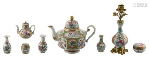 A Chinese Canton famille rose floral decorated candlestick and tea pot and cover, the roundels with court scenes, the candle stick with bronze mounts, 19th / 20thC; added a ditto various miniature porcelain, H 4,5 - 25 cm