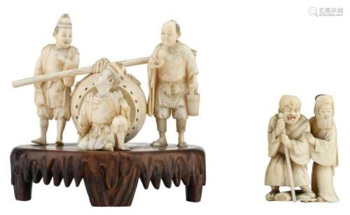 A Japanese finely carved ivory barrell shaped tobac container with figures from the daily life of the Meiji period, partially tinted, marked, on a carved wooden base; added a ditto okimono depicting an elderling and a lady, H 8,2 - 14,5 cm - Weight: about 138 - 320g (without base)