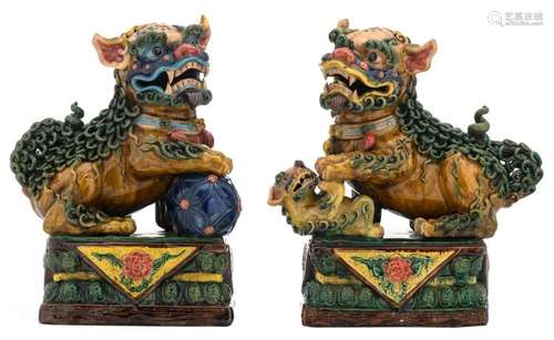 A pair of Japanese polychrome glazed earthenware Shishi, H 40 cm