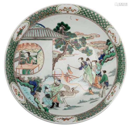 A Chinese famille verte decorated plate with an animated scene, ø 47 cm