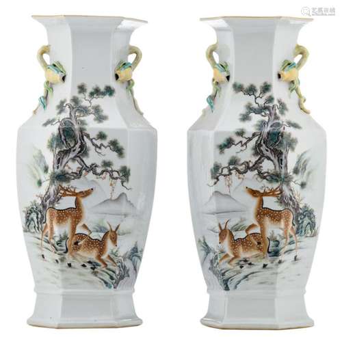 A pair of Chinese polychrome decorated hexagonal vases with deers in a landscape and a calligraphic text, the handles pomegranate shaped, H 46 cm