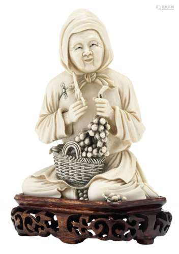 A Chinese ivory figure, depicting a seated farmer's wife, partially tinted, marked, on a matching wooden base, first half 20thC, H 18 cm (with base) - Total weight: about 492g (without base)