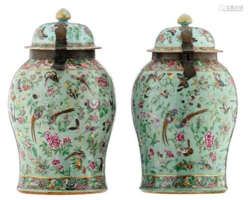 A pair of Chinese celadon ground famille rose vases and covers, decorated with birds, butterflies and flower branches, with brass mounts, 19thC, H 64 - 64,5 cm